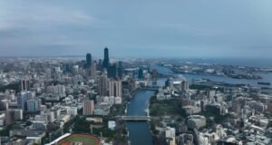 Where to Travel in March: 15 Best Places to Travel in 2026 A scenic aerial view showcasing one of the best places to travel in March, featuring a vibrant city skyline and waterfront landscape. This image highlights ideal March travel weather with clear skies and coastal charm. Perfect inspiration for spring getaways, warm-weather escapes, and global travel destinations in 2026.