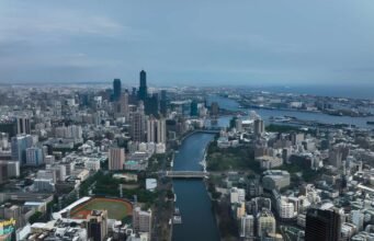 Where to Travel in March: 15 Best Places to Travel in 2026 A scenic aerial view showcasing one of the best places to travel in March, featuring a vibrant city skyline and waterfront landscape. This image highlights ideal March travel weather with clear skies and coastal charm. Perfect inspiration for spring getaways, warm-weather escapes, and global travel destinations in 2026.